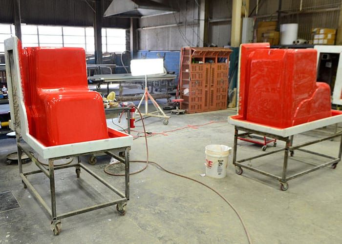 Two red production molds on rolling carts in the mold shop